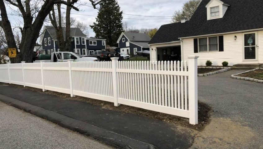 white vinyl fence installation in residential home front yard