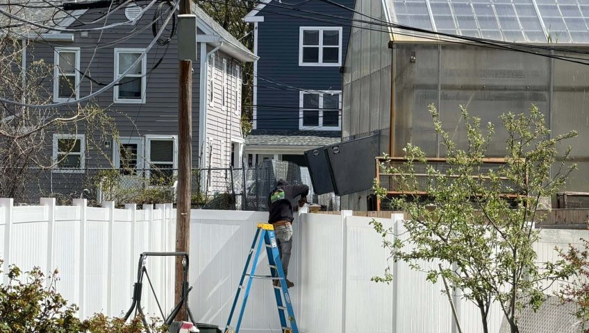 Residential vinyl fence installation near utility lines and property boundaries in Massachusetts