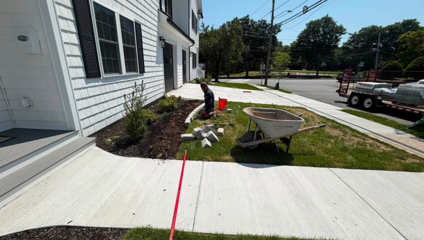 Professional landscape bed installation with mulch, edging, and shrubs by New Generation Landscaping & Fence.