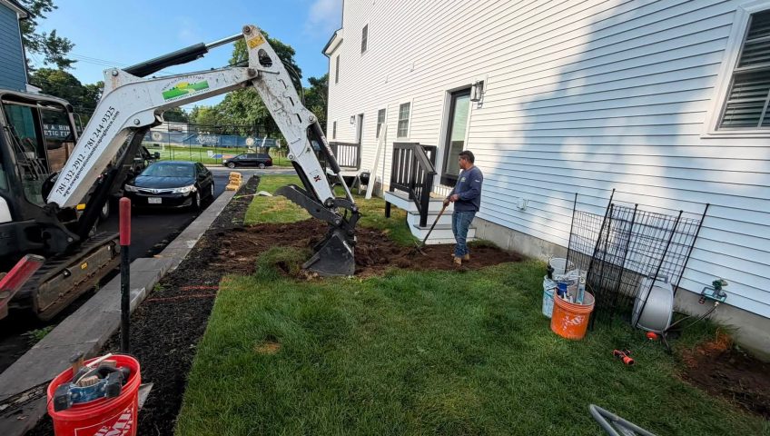 Mini excavator performing landscape excavation services for a residential backyard by New Generation Landscaping & Fence.