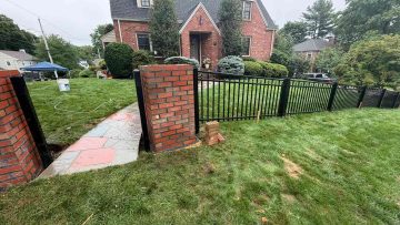 Black aluminum fence between brick columns at a Peabody MA front yard entrance