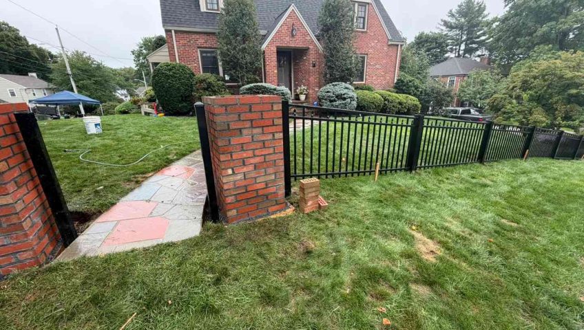 Black aluminum fence between brick columns at a Peabody MA front yard entrance